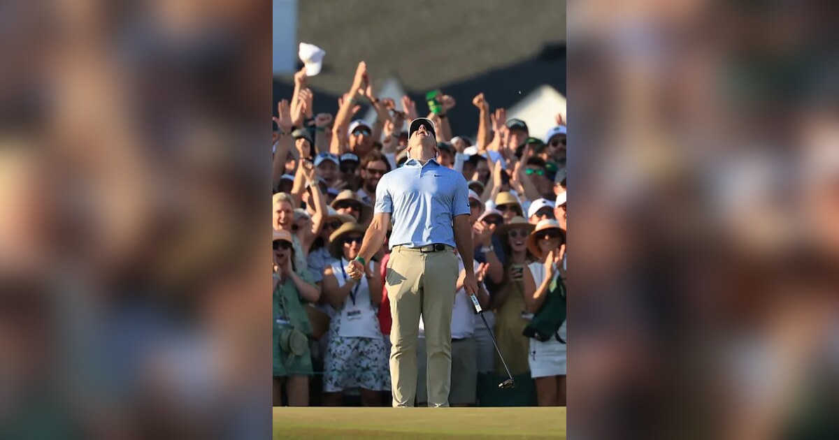 Rory McIlroy looks skyward with the gallery behind him