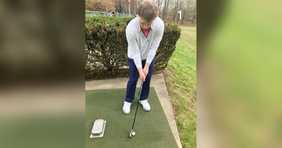Golfer demonstrating chip-shot setup