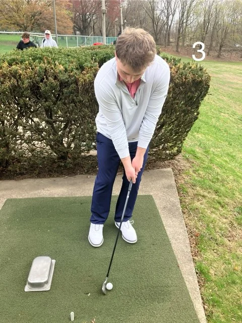 Golfer demonstrating weight favoring the lead side during a chip shot